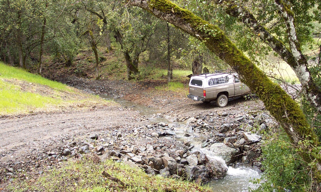 The same road has been modified to have an armored fill at the stream crossing zone—a dip that is covered by rocks which will still allow cars to pass even as the stream flows.