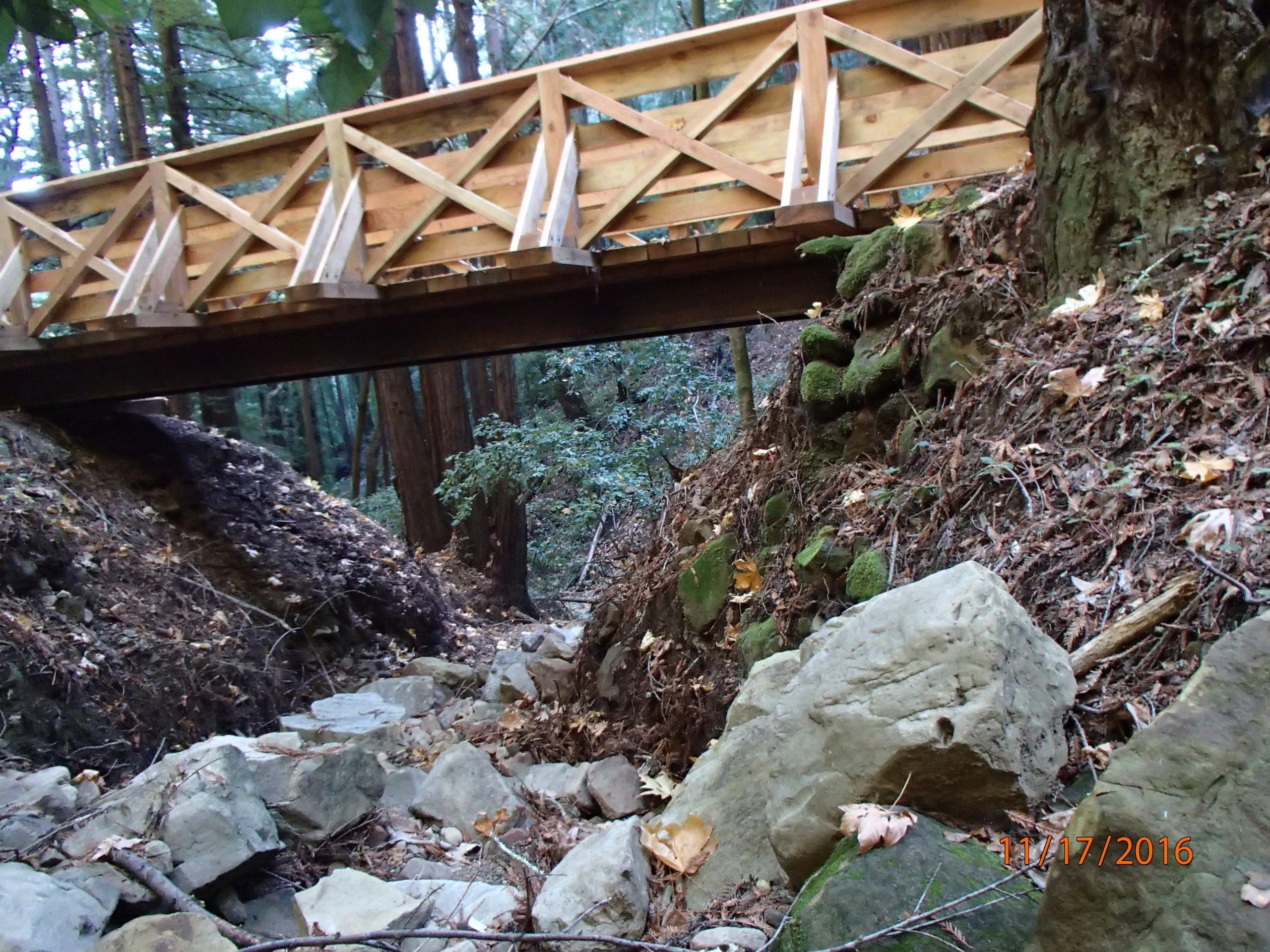 The same road has converted the culvert stream crossing to a foot bridge, constructed out of wood, leaving plenty of space for the stream to flow.